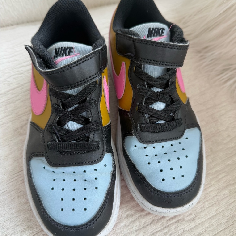 Nike Black and Pink Sneakers with Unique Design and Supportive Closure